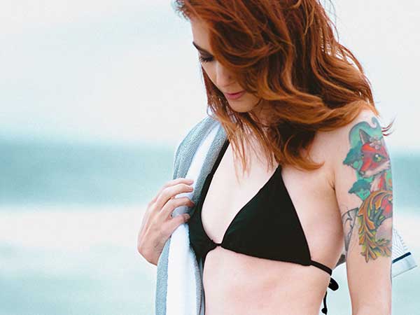 Girl on Beach with tattoo
